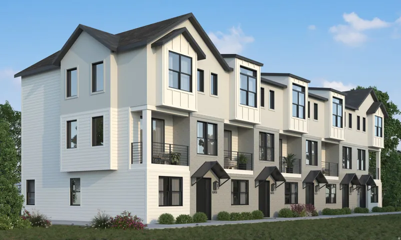 Modern multi-level townhome architecture featuring varied exterior materials, individual balconies with black railings, and decorative awnings over entryways