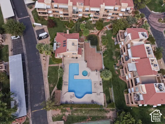 Pool with integrated spa, expansive deck, and surrounding green space