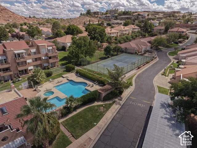 Community swimming pool with an integrated spa, surrounded by a paved deck