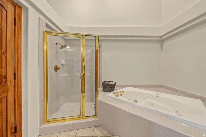 Walk-in shower with gold-tone frame and hardware