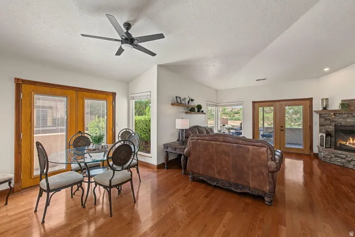 Vaulted ceilings, wood-finish flooring, and a stone-clad fireplace