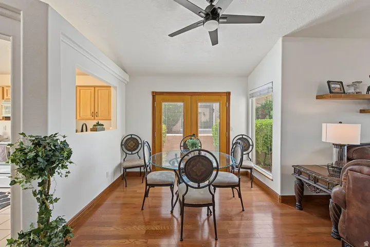 Wood-finish flooring throughout, with a ceiling fan light fixture