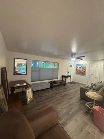 Wood-finish flooring throughout, paired with a ceiling fan light fixture