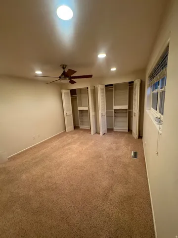Recessed ceiling lighting, ceiling fan, and window provide illumination