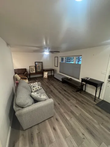 Wood-finish flooring, recessed lighting, and a ceiling fan with integrated lighting