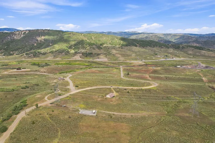 Expansive natural landscape with rolling hills and distant mountains