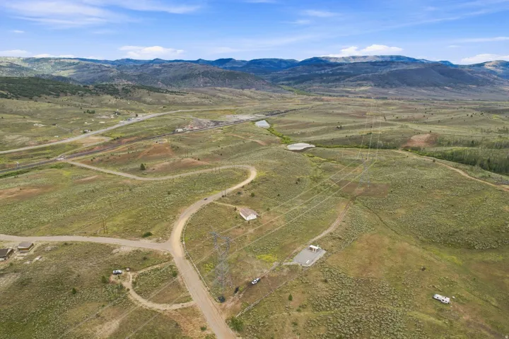 Expansive natural landscape featuring rolling hills and distant mountains