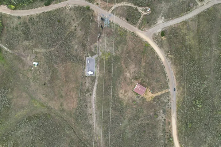 Aerial Photograph. Overview of the property, including structures, access roads, and utility lines