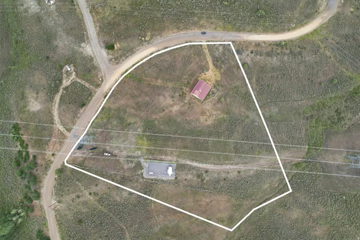 Aerial Property Boundary. Illustrating the defined perimeter of the property, including structures and surrounding terrain