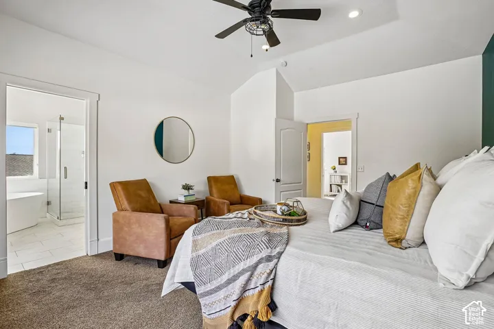 Vaulted ceilings, recessed lighting, and a ceiling fan create an open atmosphere