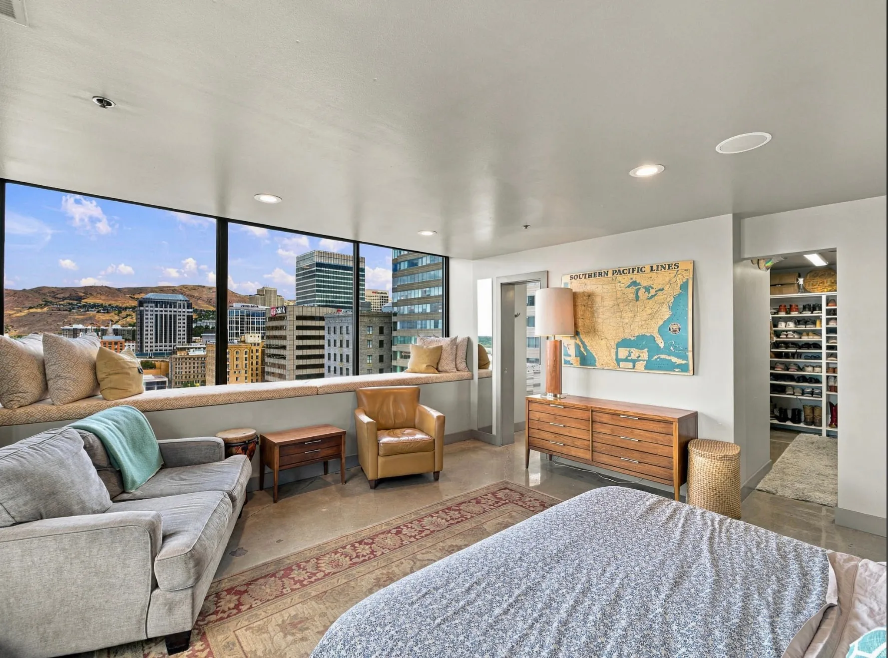 Expansive floor-to-ceiling windows with a built-in window seat and integrated storage