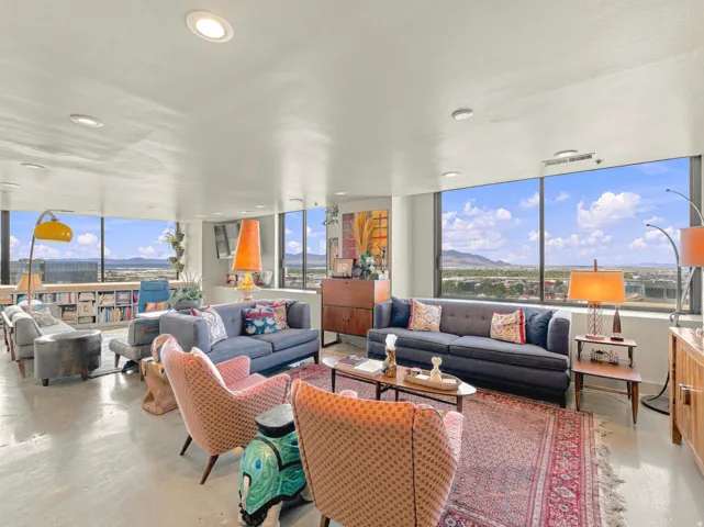 Panoramic windows, recessed ceiling lighting, built-in shelving, concrete flooring