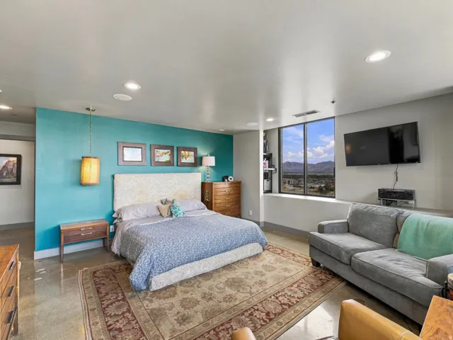 Recessed lighting, large format window, polished concrete flooring, built-in shelving, accent wall