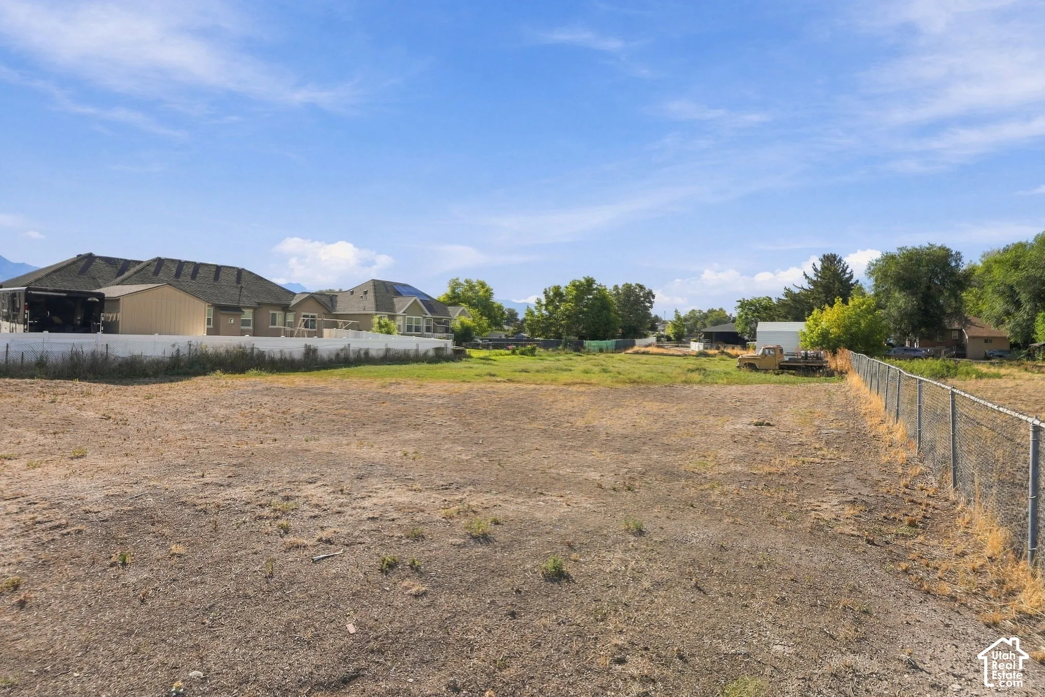 Expansive undeveloped land parcel with surrounding residential properties