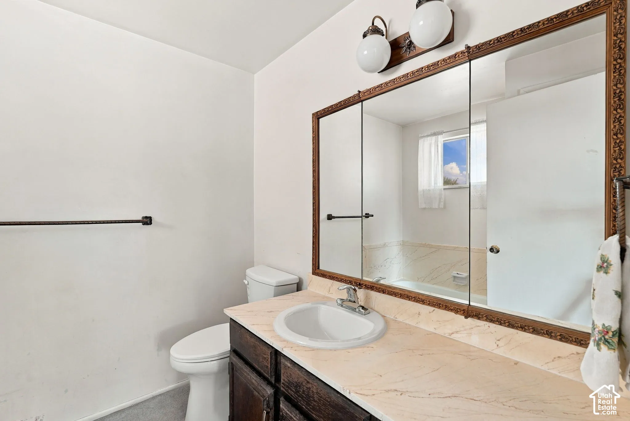 Bathroom featuring a single vanity, undermount sink, and a framed mirrored medicine cabinet