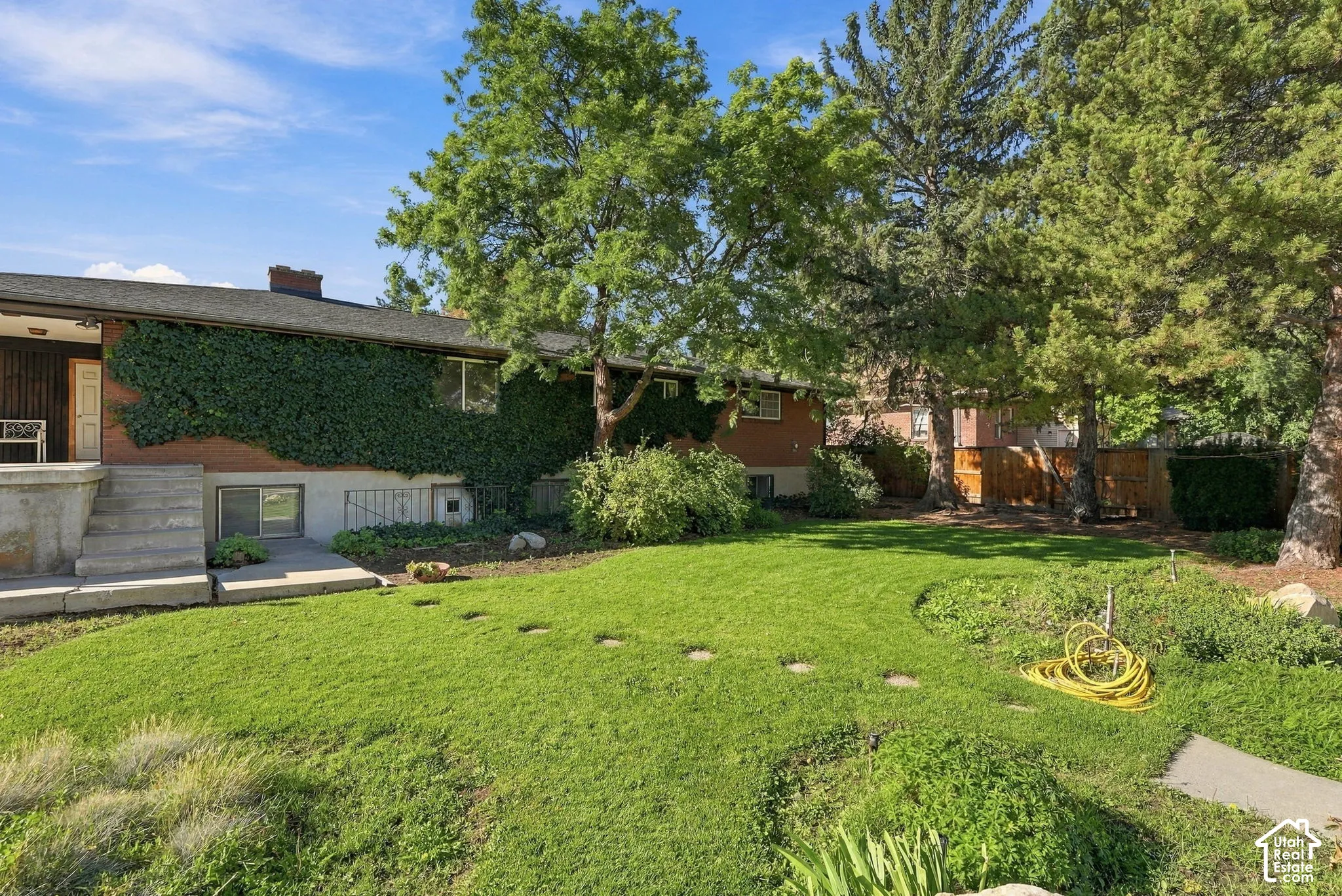 Extensive green lawn with established trees and mature landscaping