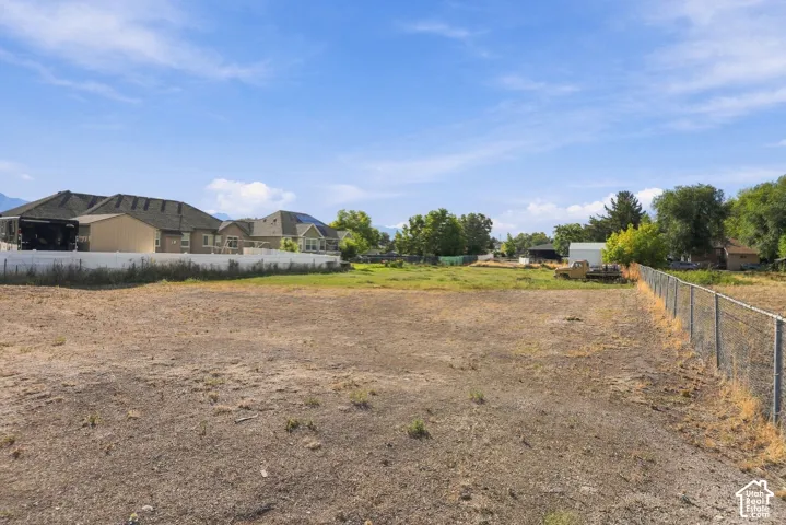 Expansive undeveloped land parcel with surrounding residential properties