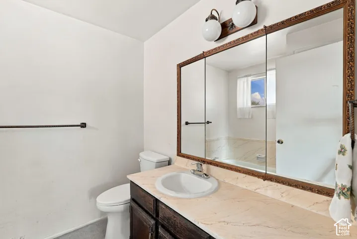 Bathroom featuring a single vanity, undermount sink, and a framed mirrored medicine cabinet