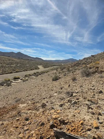 Expansive desert landscape with natural terrain and distant mountains