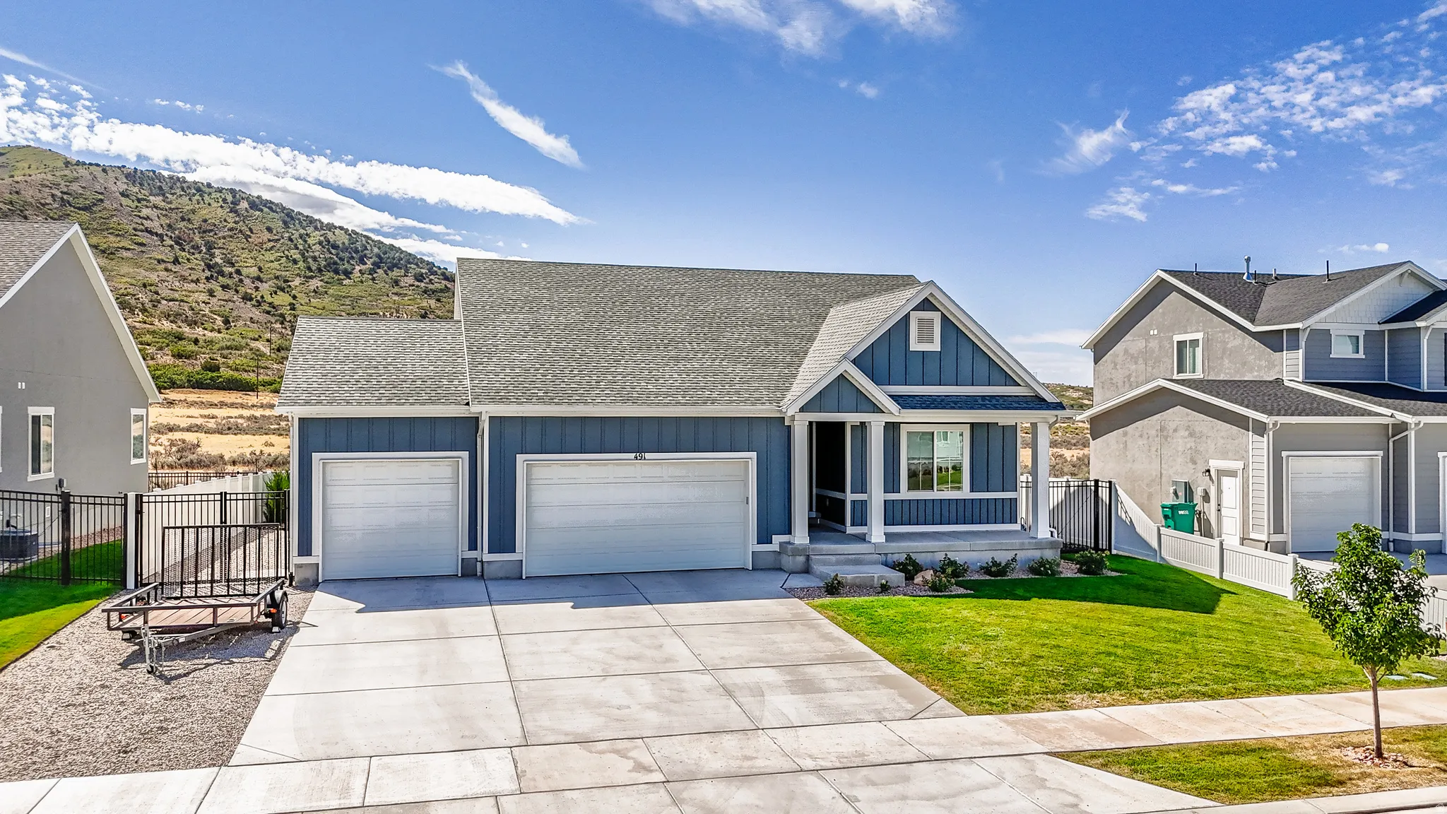 Traditional style residence with a covered front porch, a two-car garage, and a concrete driveway