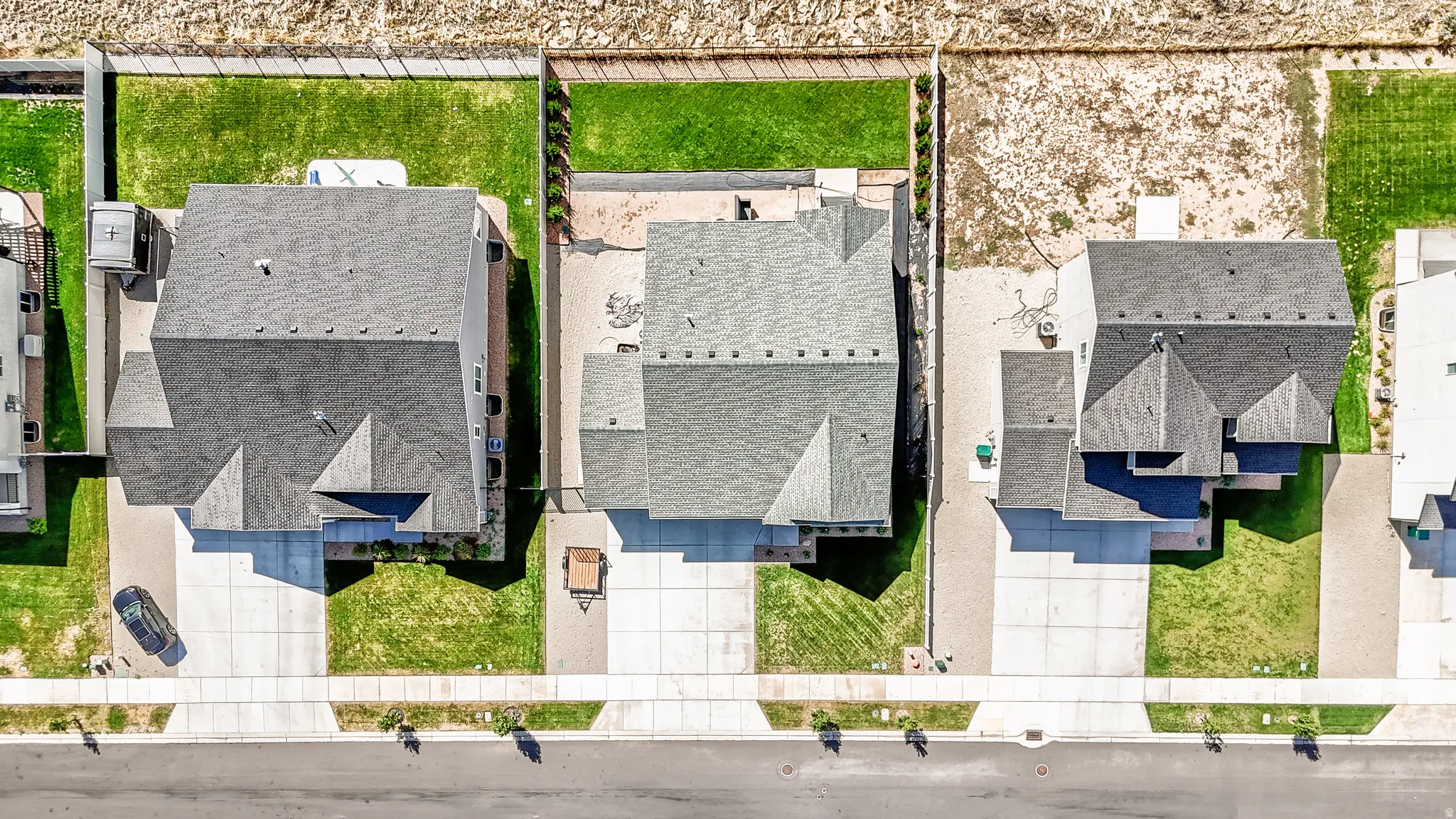 Pitched rooflines, multiple gable features, and a concrete driveway