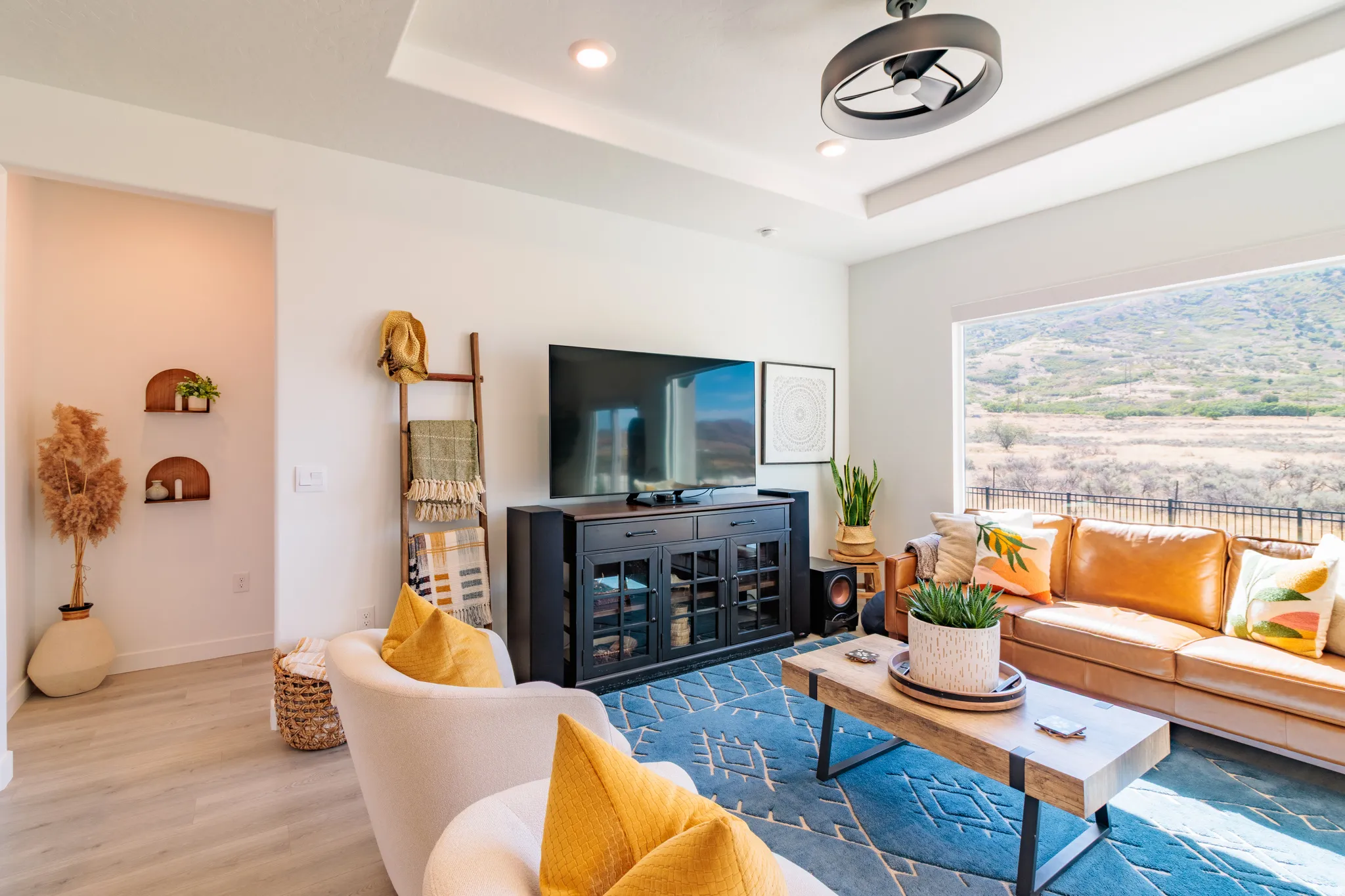 Tray ceiling with recessed lighting, integrated ceiling fan, and expansive window
