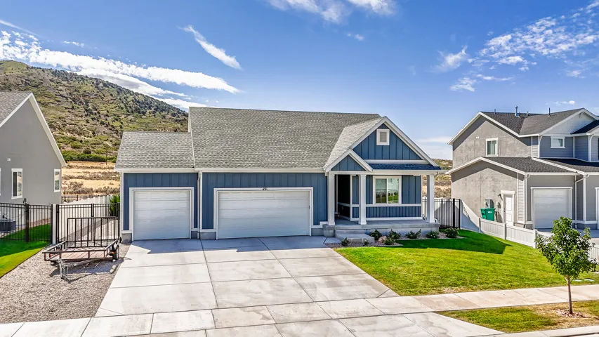 Traditional style residence with a covered front porch, a two-car garage, and a concrete driveway
