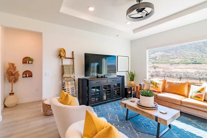 Tray ceiling with recessed lighting, integrated ceiling fan, and expansive window