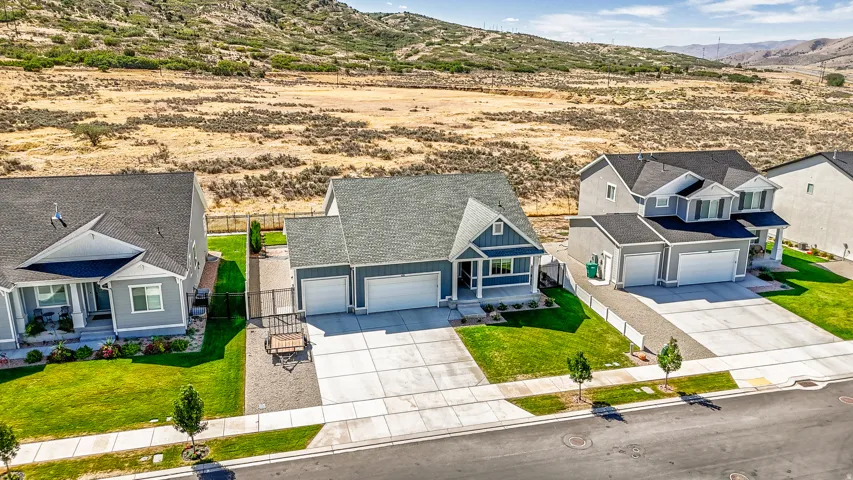 Ranch-style residence featuring a prominent front porch and a two-car garage