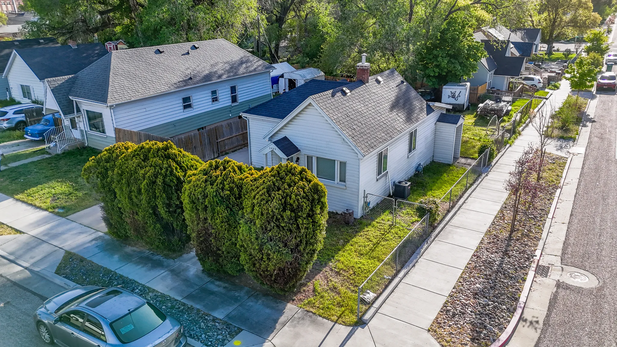 White siding exterior with a dark shingle roof