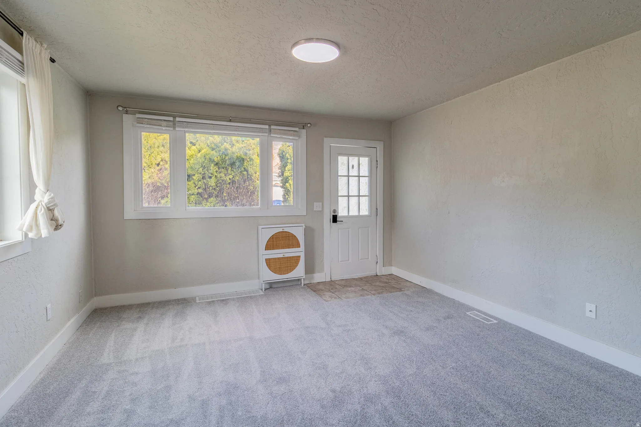 Light gray carpeting with neutral wall tones