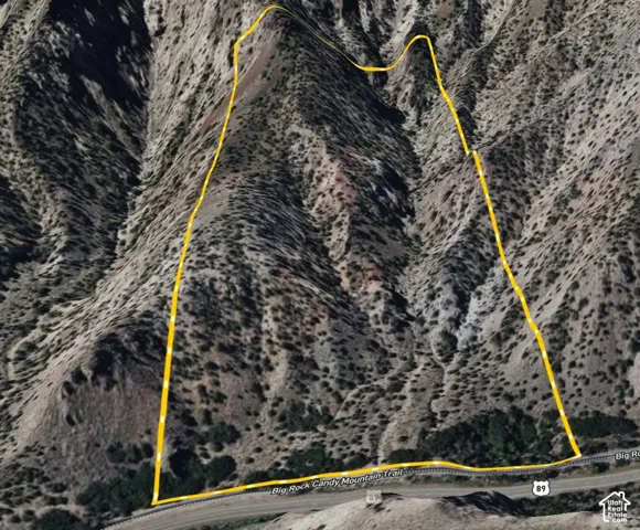 Aerial property boundary map. Outlining the perimeter of the property in a mountainous terrain, with an adjacent road labeled "Big Rock Candy Mountain Trail" and "89"