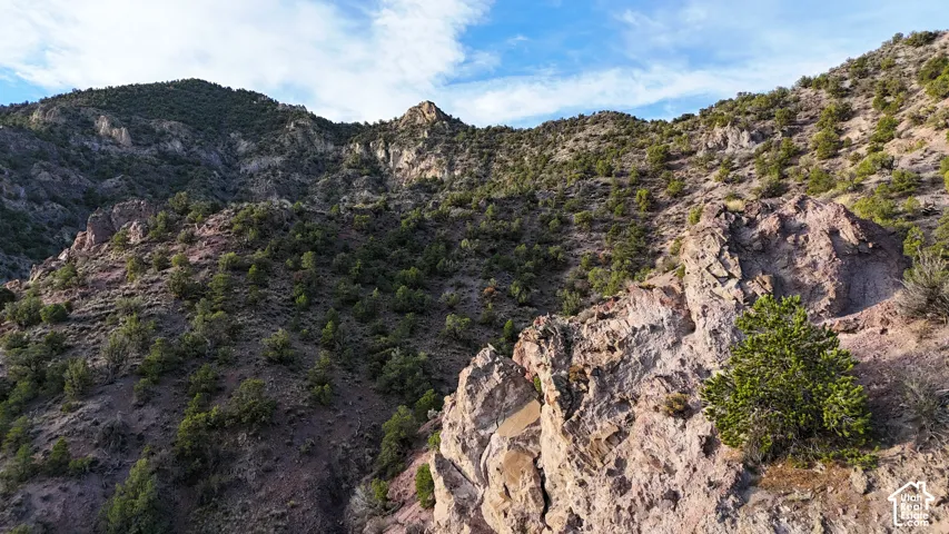 Expansive mountainous terrain featuring natural rock formations and abundant evergreen vegetation
