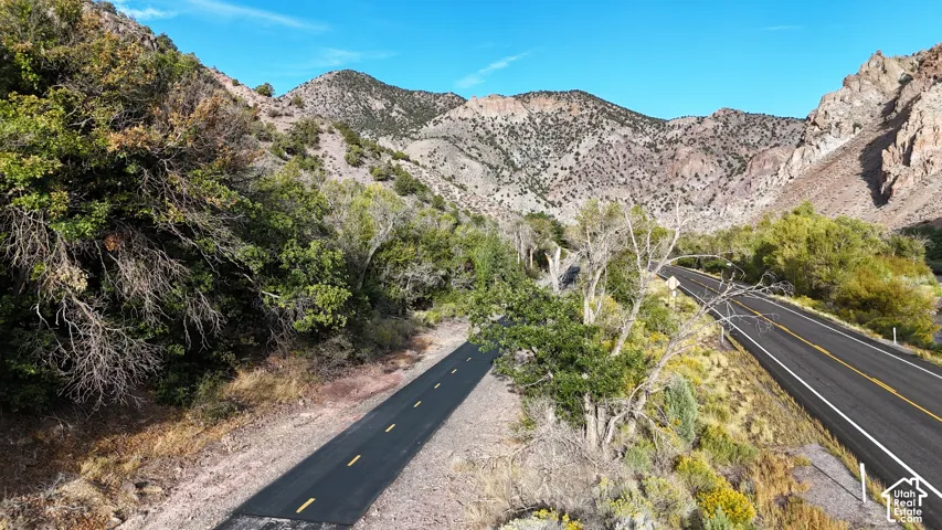 Mountainous landscape featuring a paved roadway and a dedicated path