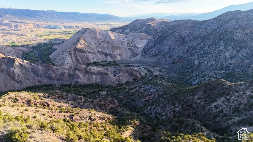 Expansive mountainous terrain featuring diverse rock formations and natural vegetation