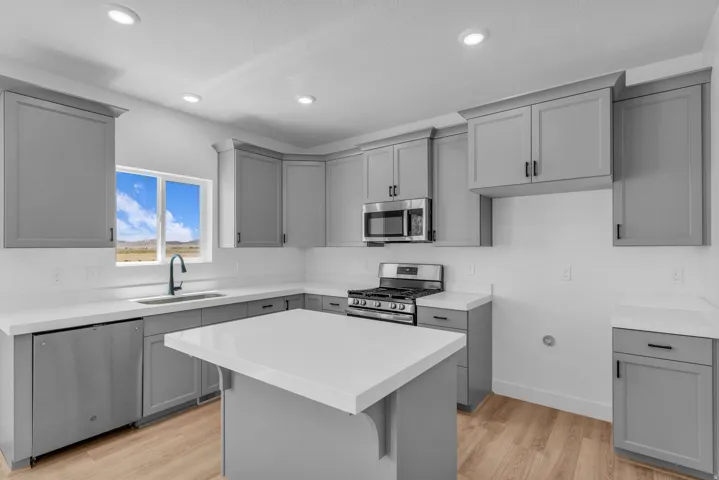 Terrific kitchen with 42" uppers, painted wood cabinets, quartz slab countertops, gas range, microwave, dishwasher and disposal.
