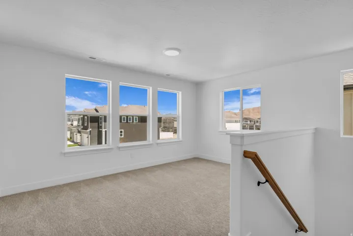 Large family room/loft area at top of stairs with great windows.