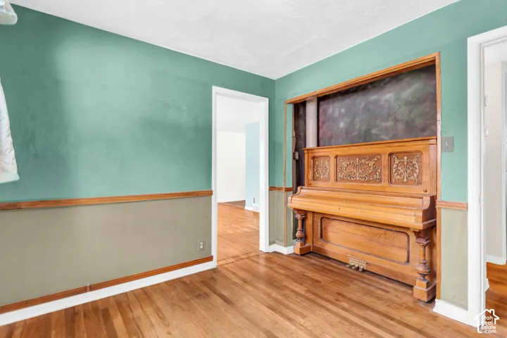 Wood-finish flooring throughout, with a decorative built-in niche featuring ornate carved details