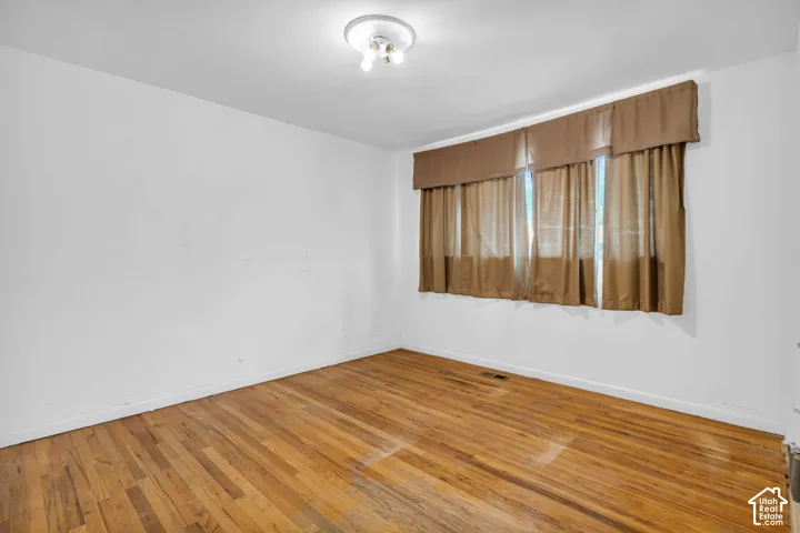 Hardwood flooring and a flush-mount light fixture