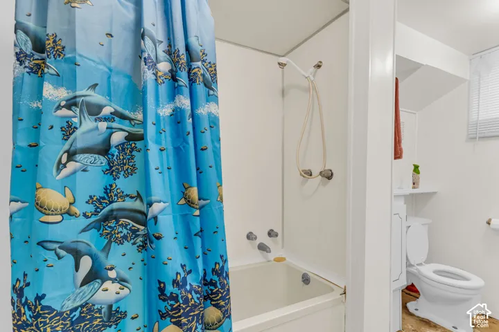 Bathtub with white surround and wall-mounted shower fixture
