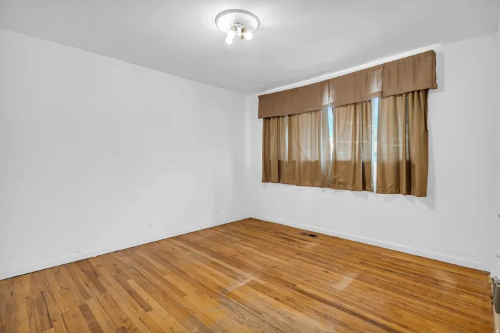 Hardwood flooring and a flush-mount light fixture