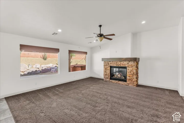 Stone-clad fireplace with wood-finish mantel and gas insert
