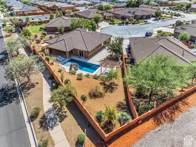 Exterior featuring a tile roof, stucco siding, and an in-ground swimming pool