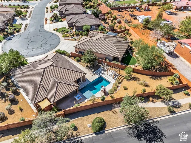 Tile roof home featuring a private swimming pool, pergola, and desert landscaping