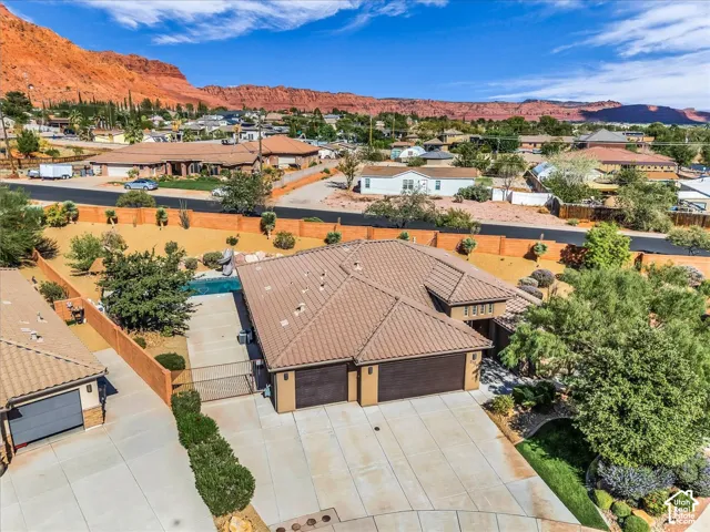 Mediterranean-style architecture with an attached two-car garage, a detached single-car garage, and a swimming pool