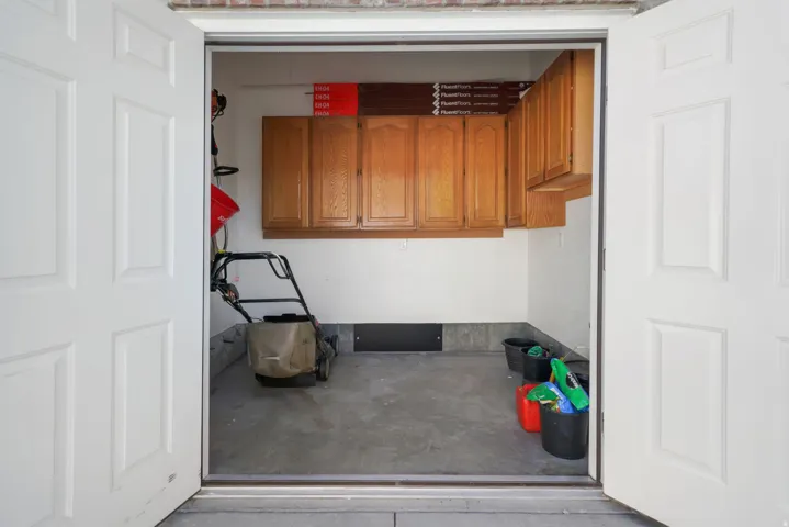 Room with concrete flooring and built-in wood cabinetry