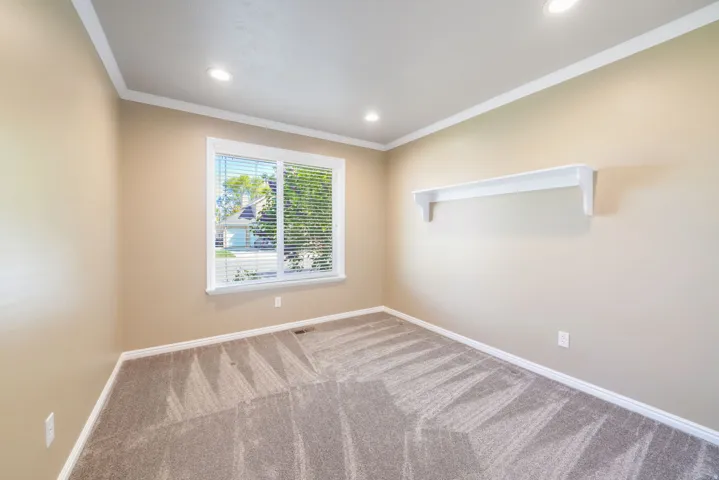Neutral-toned walls complement the textured carpeting