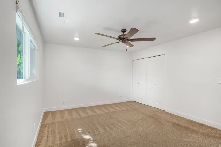 Neutral wall color, recessed lighting, ceiling fan, carpet flooring, and bi-fold closet doors