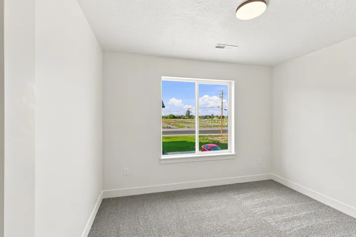 Recessed lighting, plush carpeting, and a dual-pane window