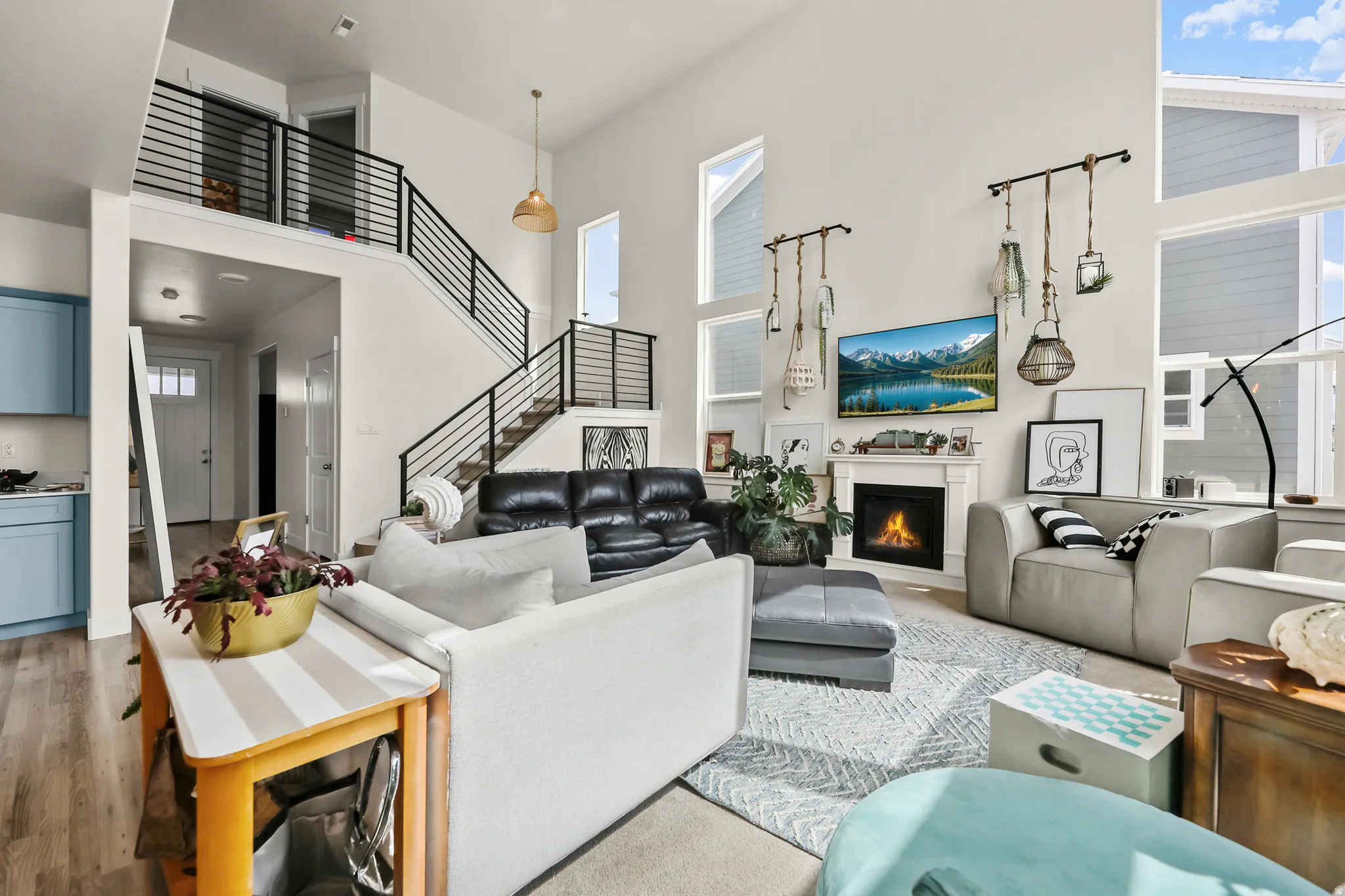 Two-story living area with high ceilings, featuring a gas fireplace